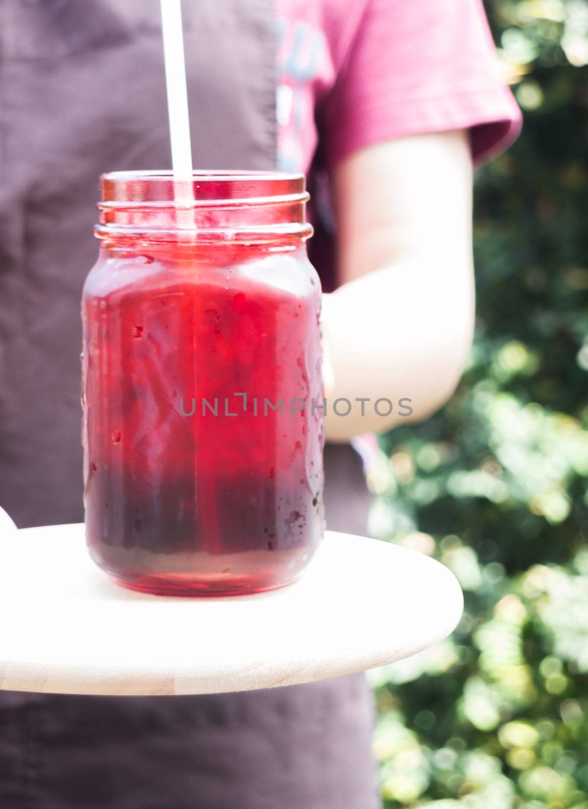 Barista serving iced black coffee, stock photo