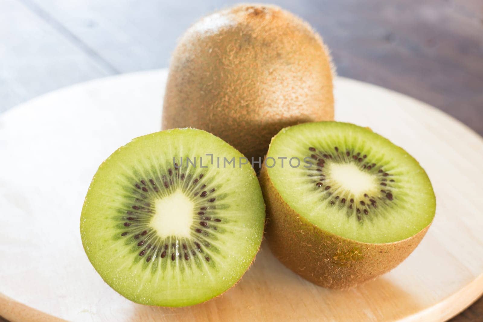 Kiwi fruit on brown wooden background, stock photo
