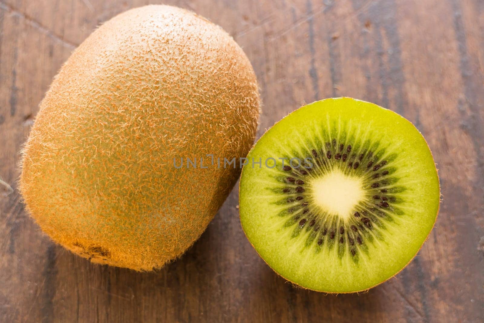 Kiwi fruit on brown wooden background, stock photo