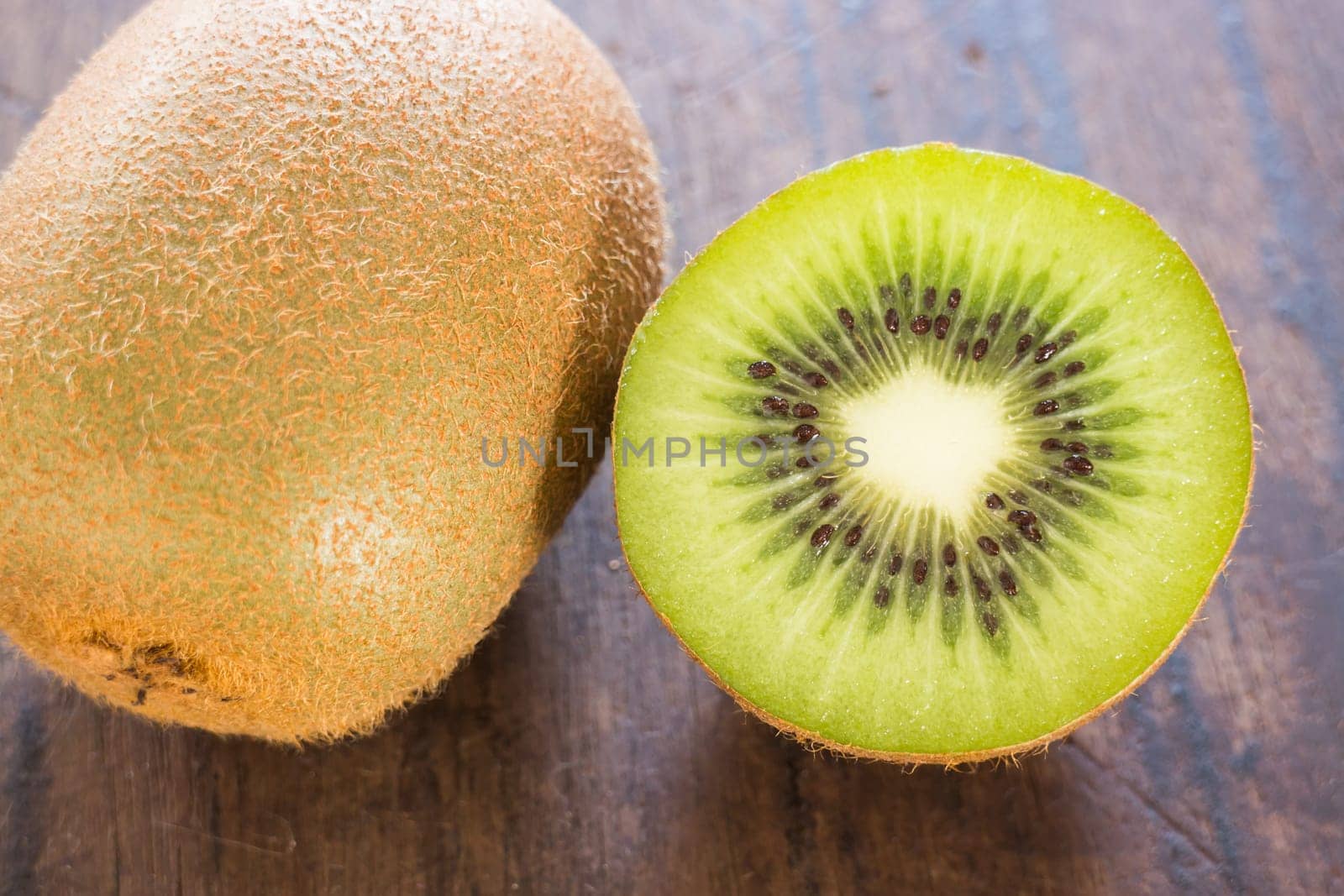 Kiwi fruit on brown wooden background, stock photo