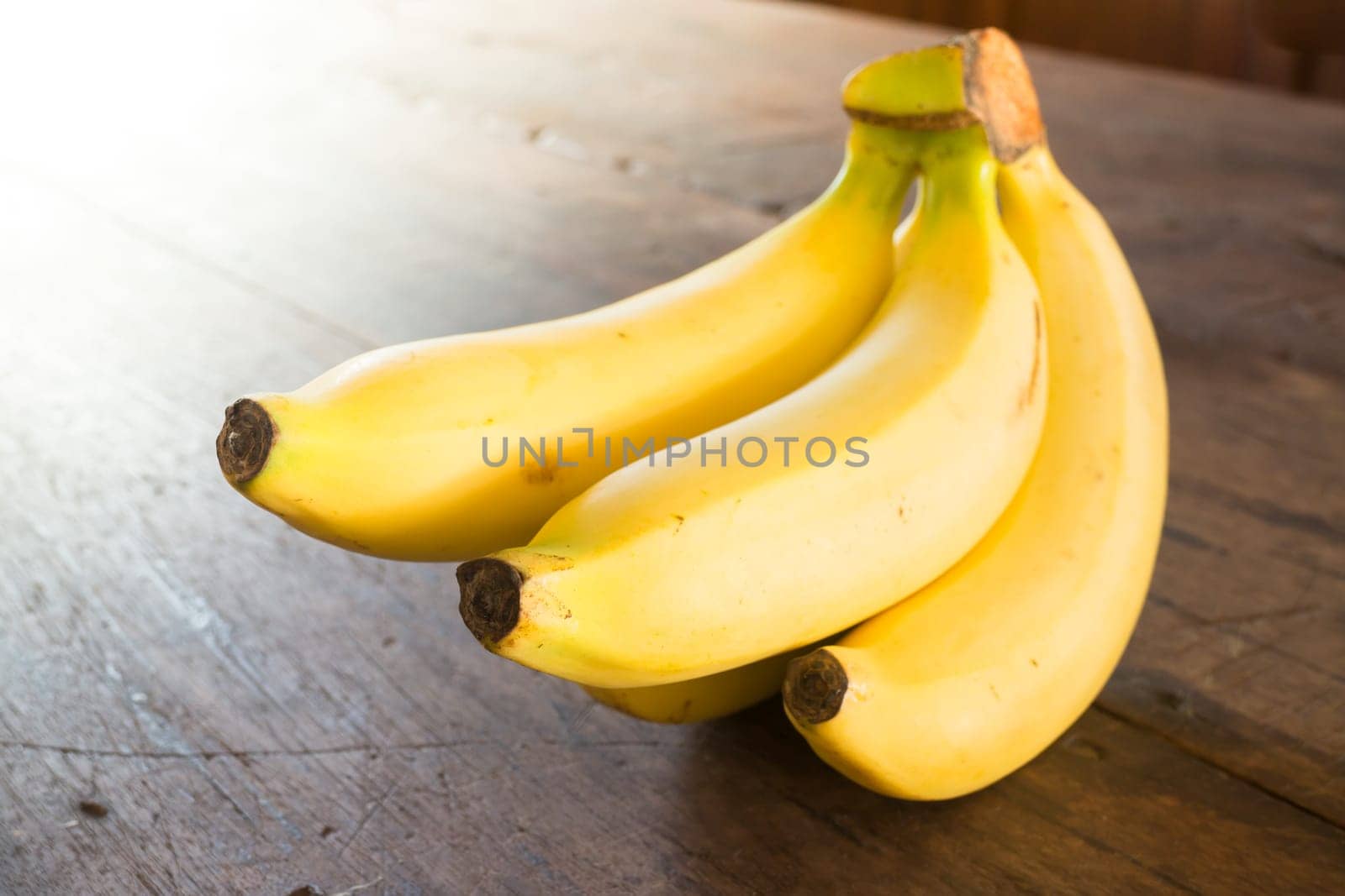 Banana on brown wooden background, stock photo