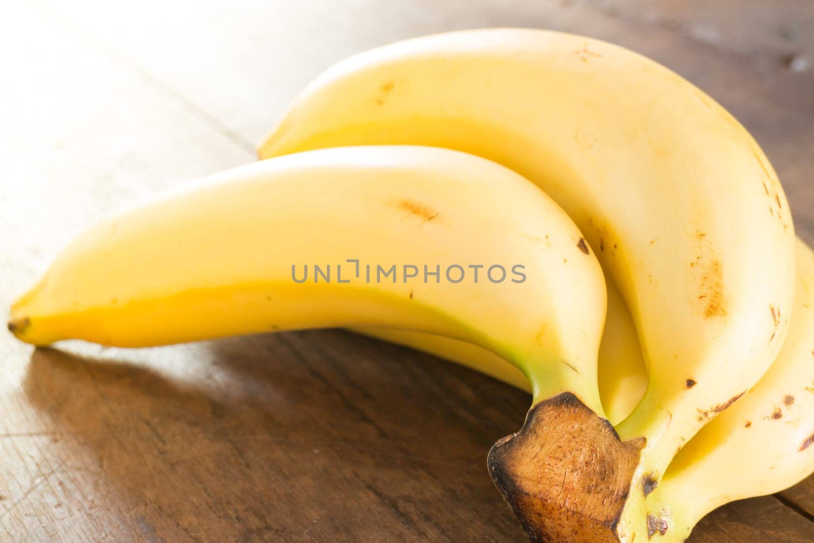 Banana on brown wooden background, stock photo