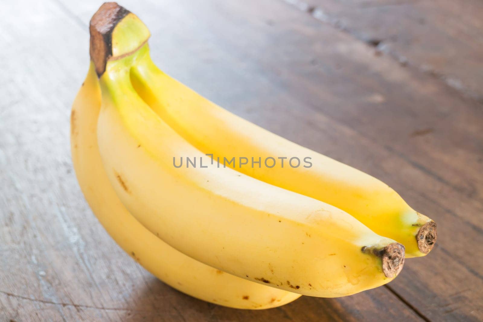 Banana on brown wooden background, stock photo