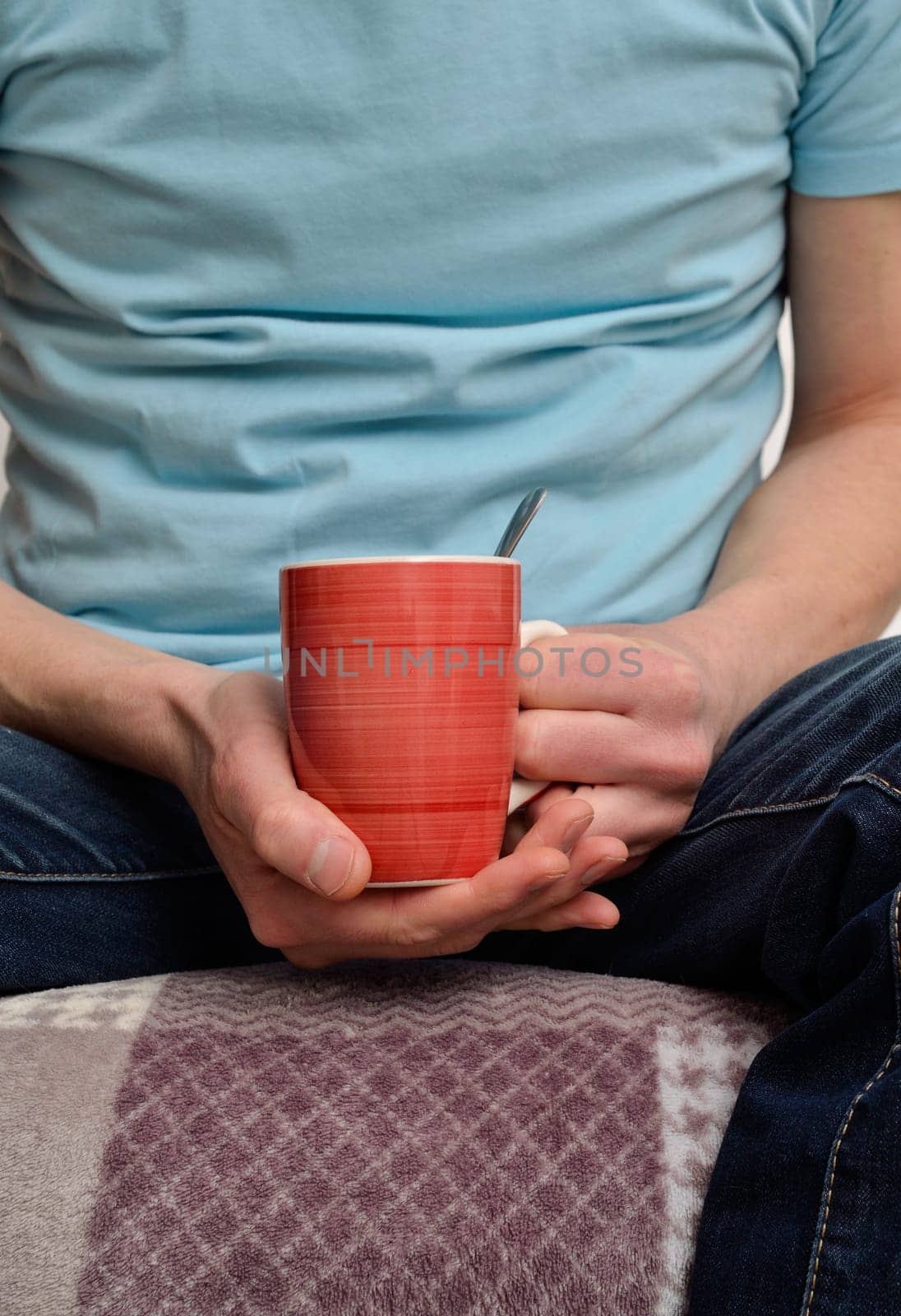 Young man on a sofa with a cup of coffee