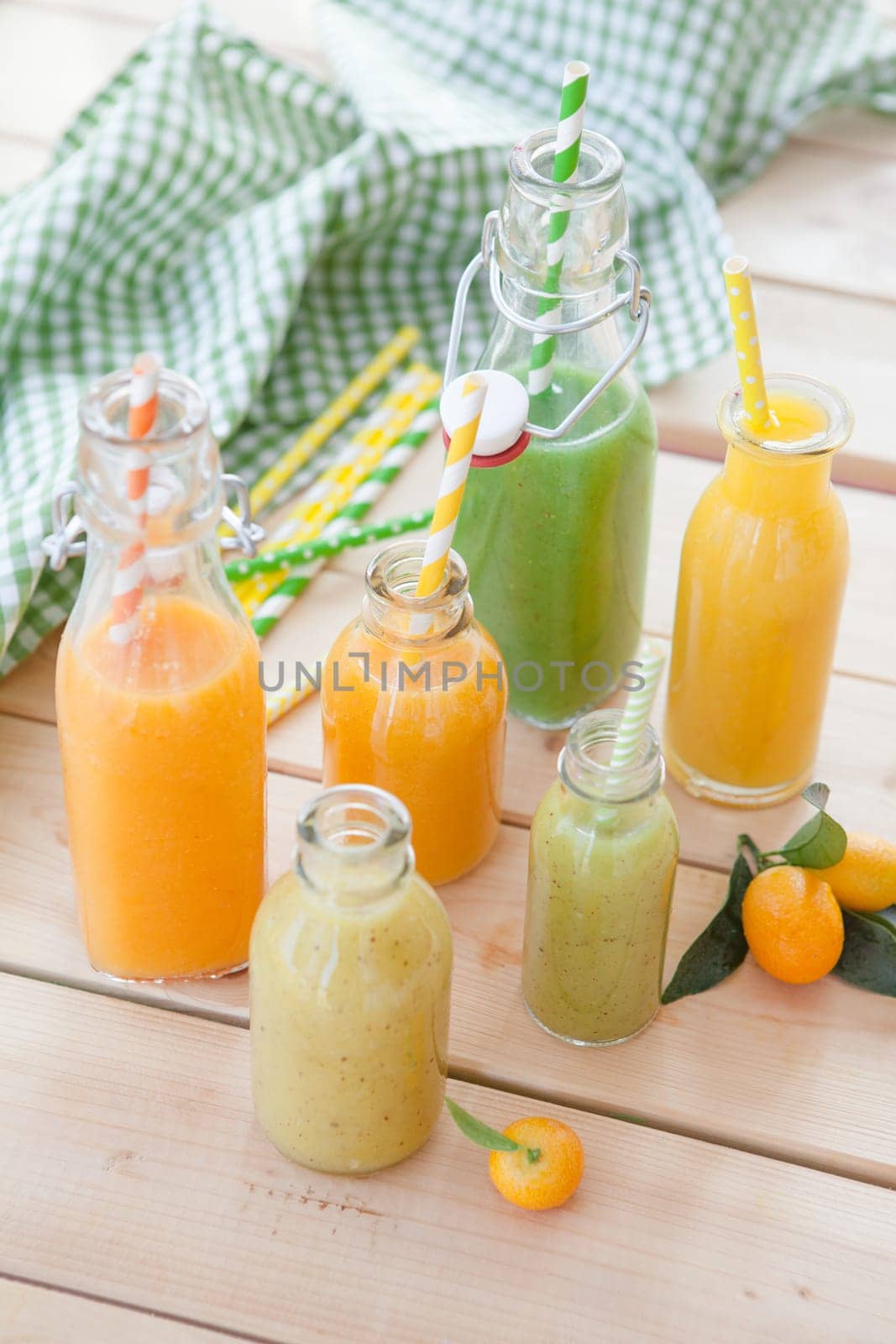 Various colorful smoothies in small bottles