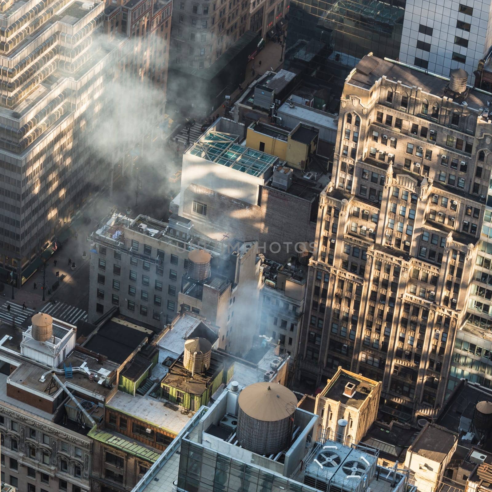 New York City. Manhattan rooftops illuminated at sunrise. Square composition. Warm morning colors.