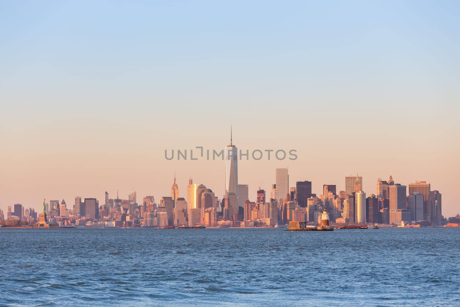 New York City Manhattan downtown skyline at sunset with skyscrapers illuminated over Hudson River panorama. Square composition, copy space.