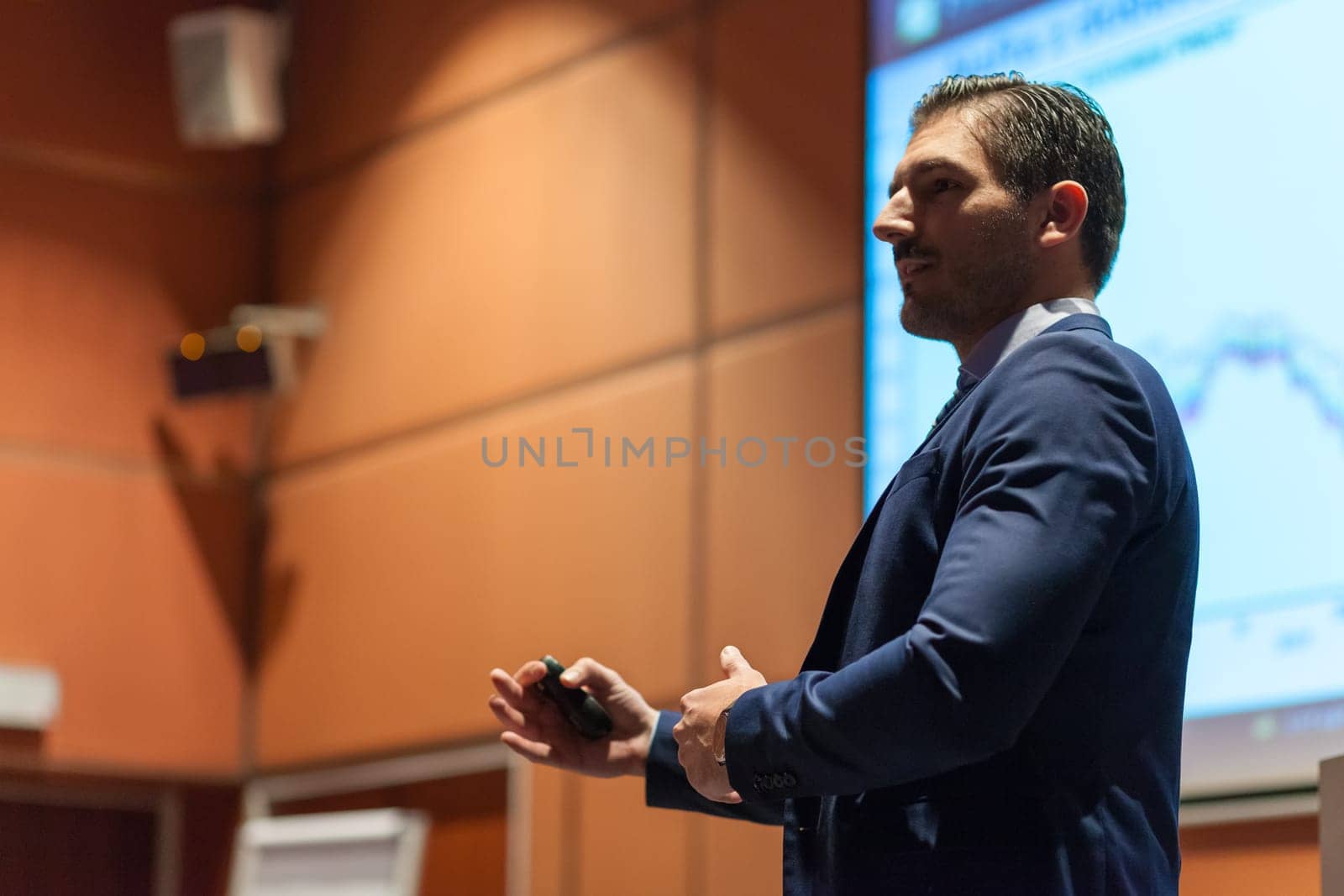 Speaker giving talk on podium at Business Conference. Entrepreneurship club. Horisontal composition.