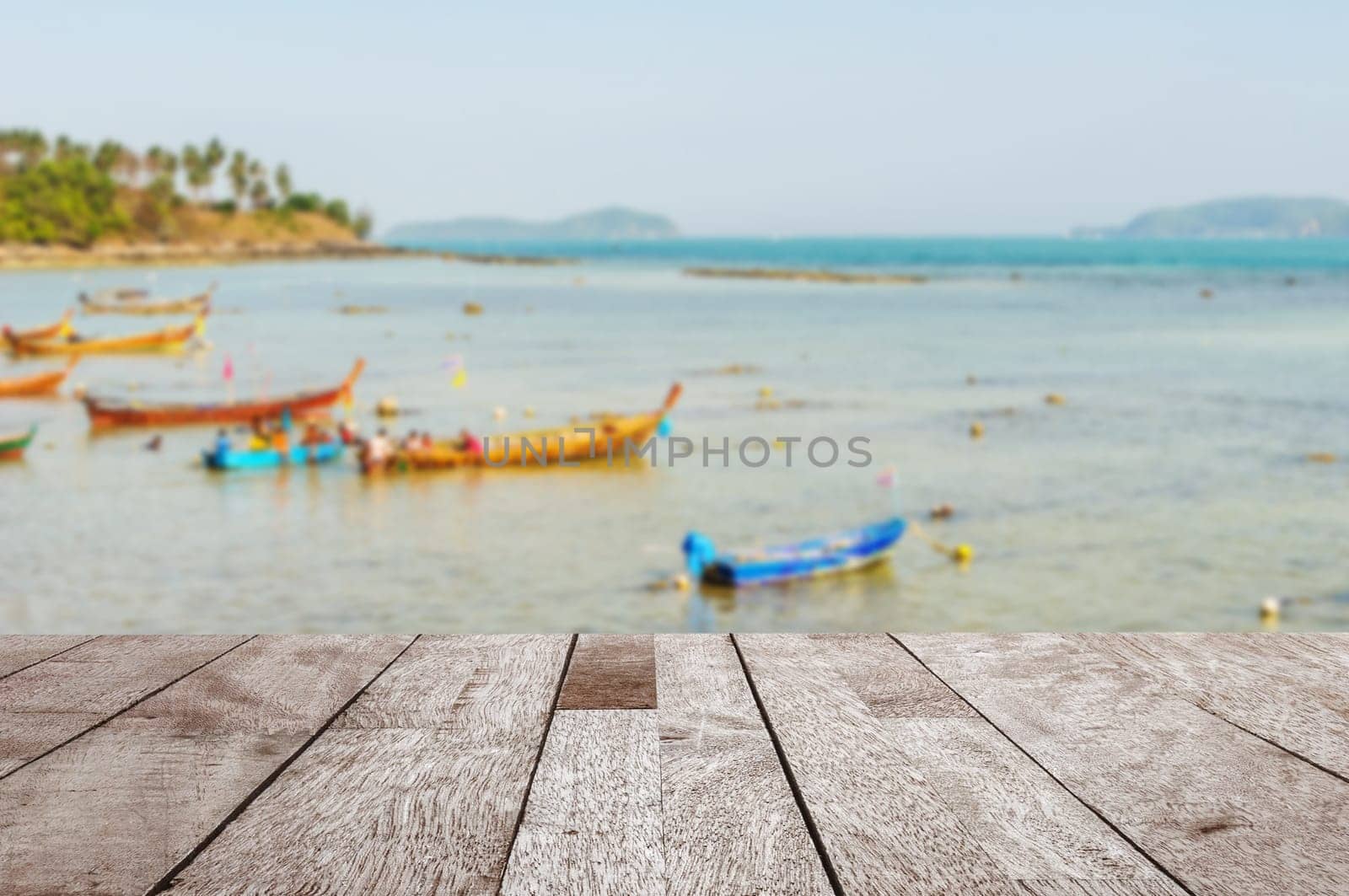 Wood table top on blurred blue sea and fishing boat with some people - Can be used for display or montage your products