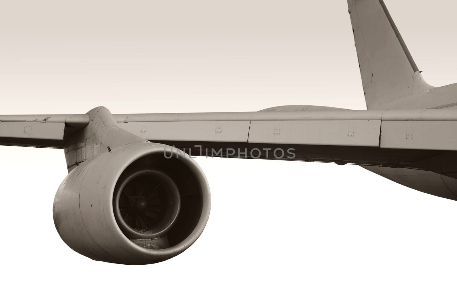 A close-up of an aircraft turbine on the side wing of a passenger plane.