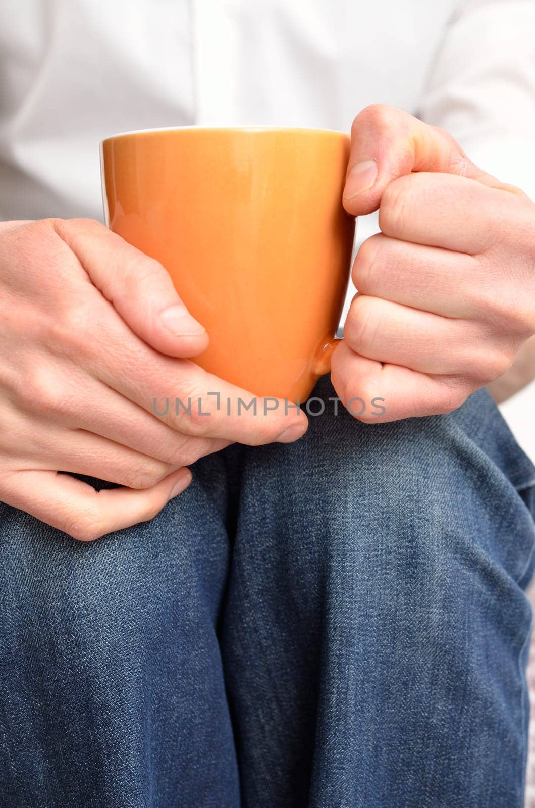 Man on a sofa with a pot of coffee