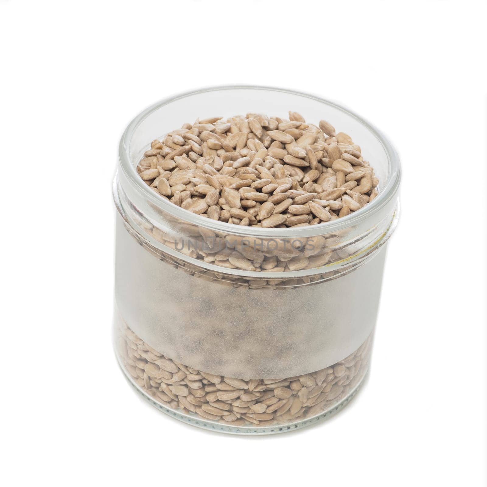 Sunflower seeds in a glass on a white table
