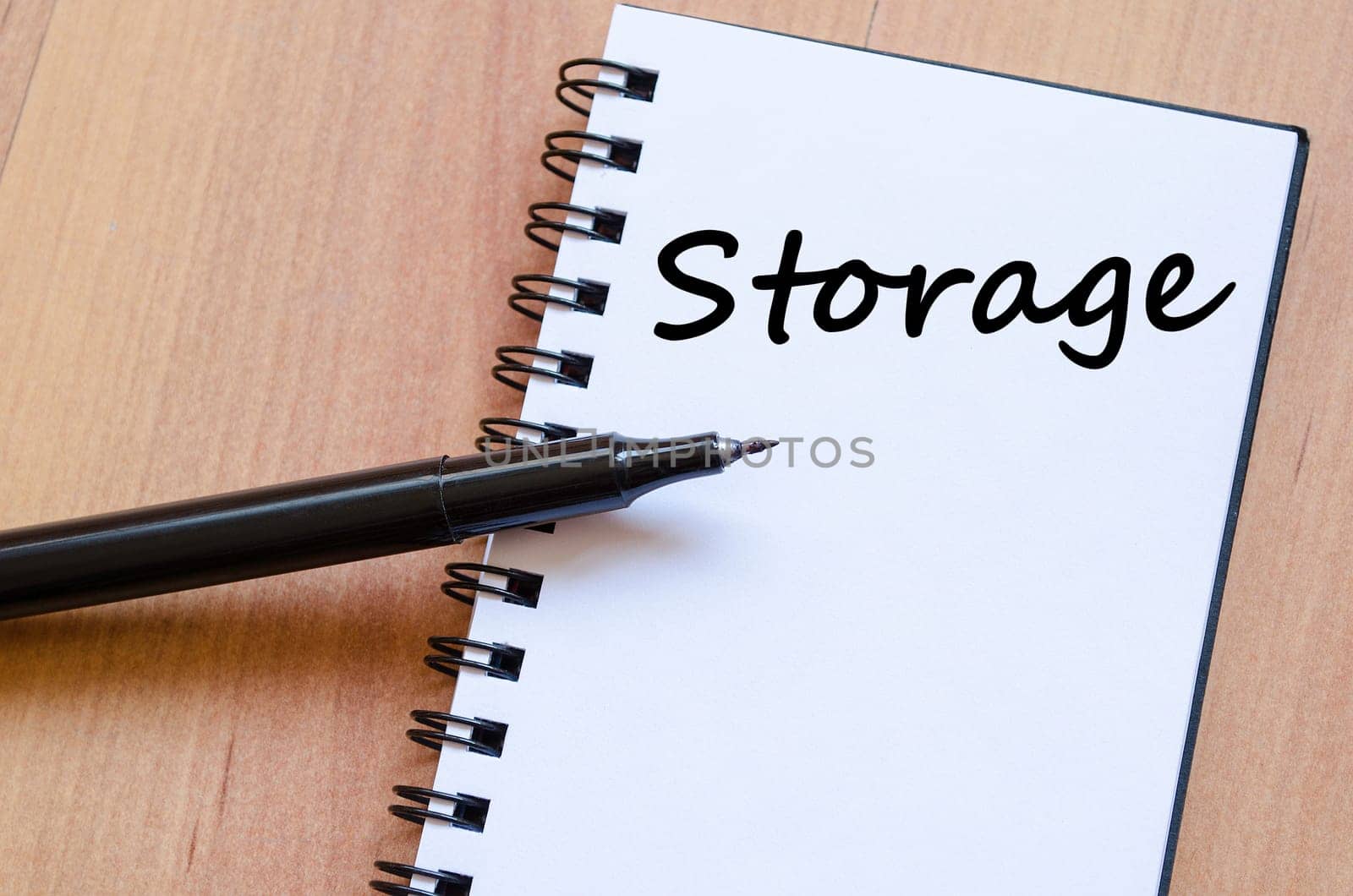 Storage text concept write on notebook with pen
