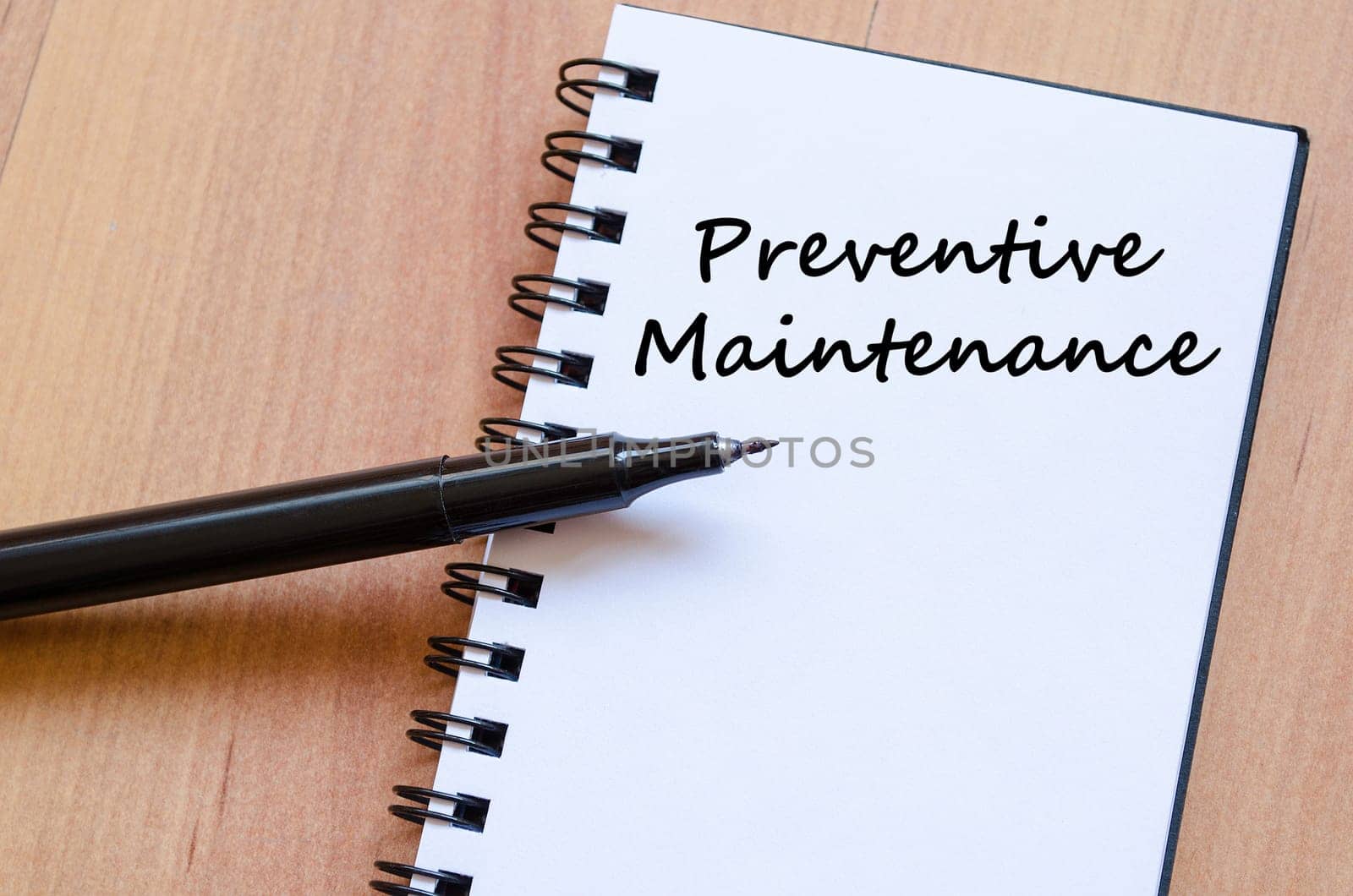 Preventive maintenance text concept write on notebook with pen