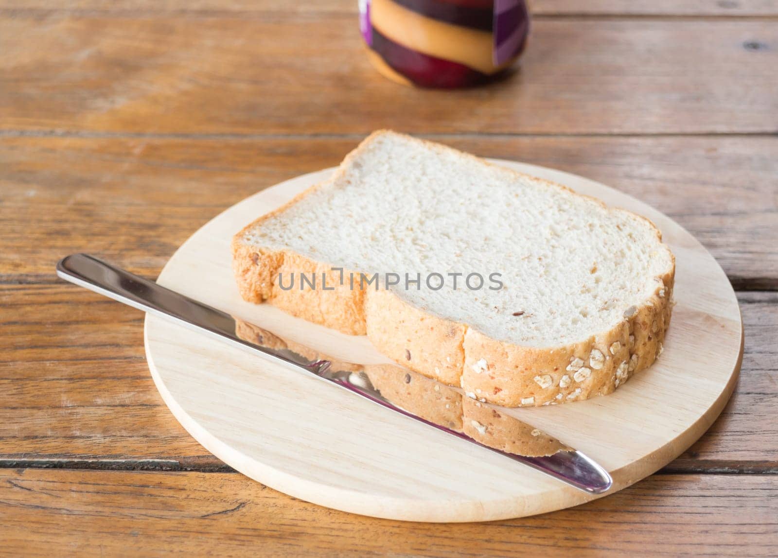Whole grain bread on wooden plate, stock photo