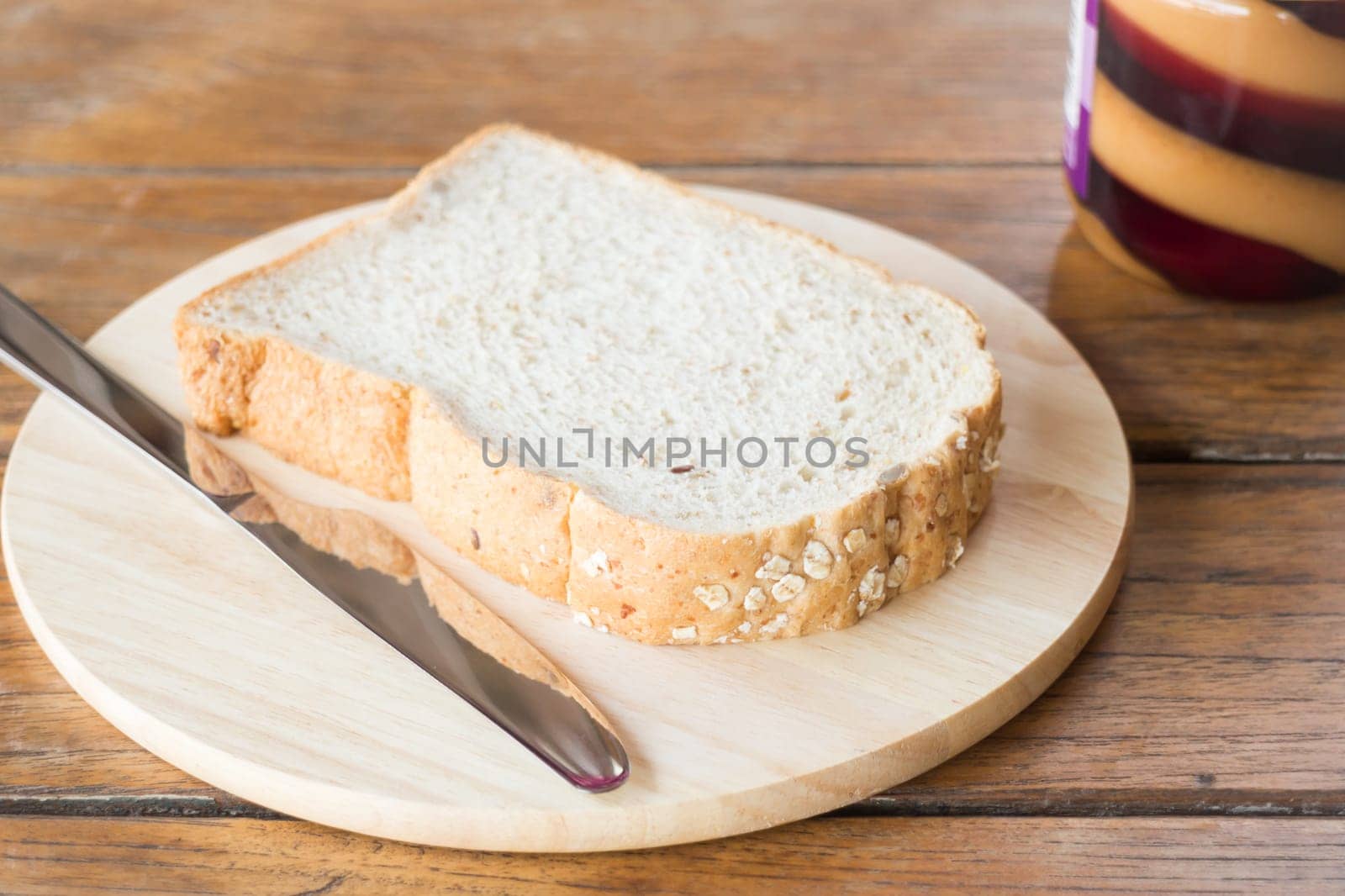 Whole grain bread on wooden plate, stock photo