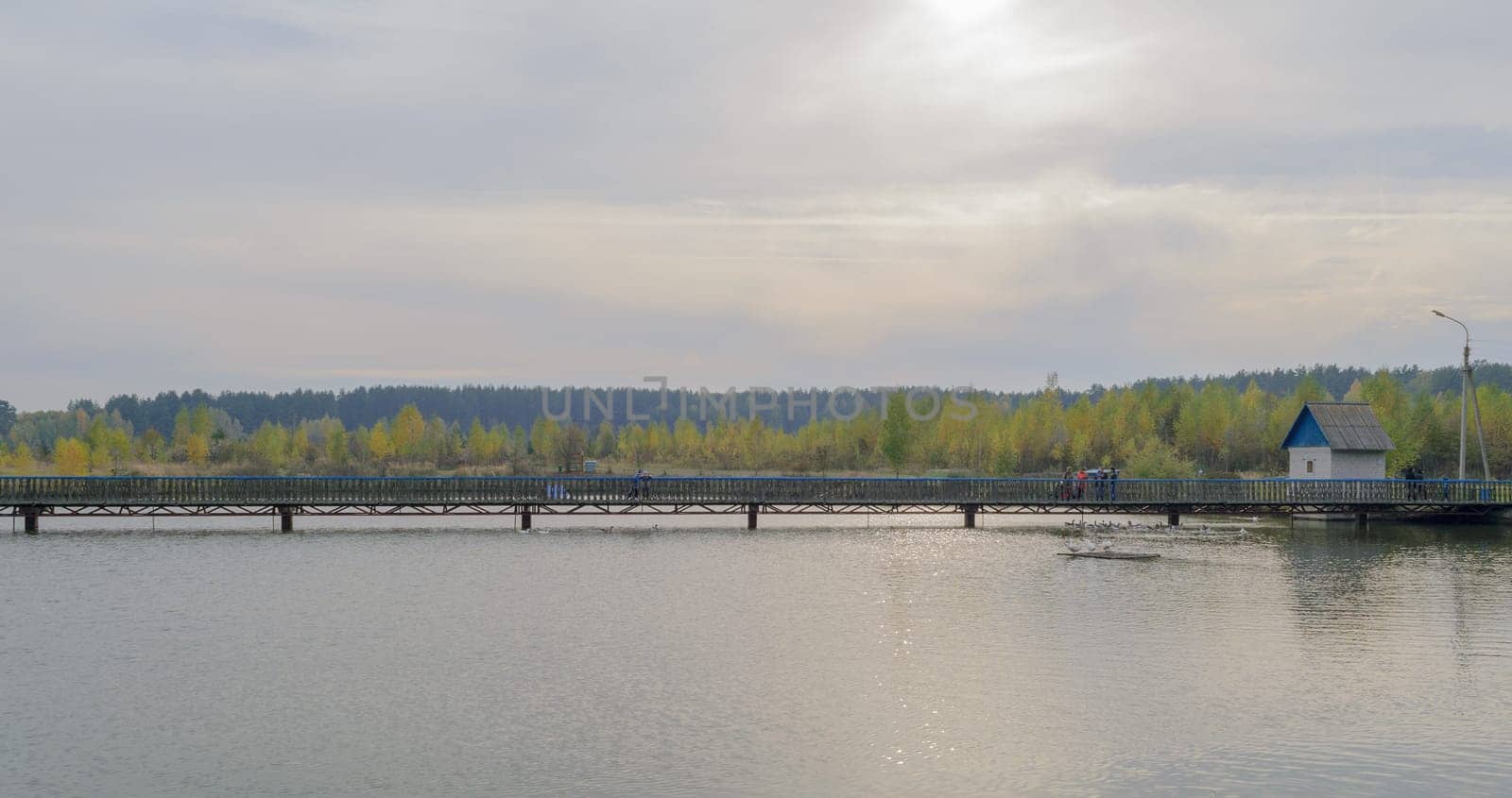 Long pedestrian bridge across the lake.