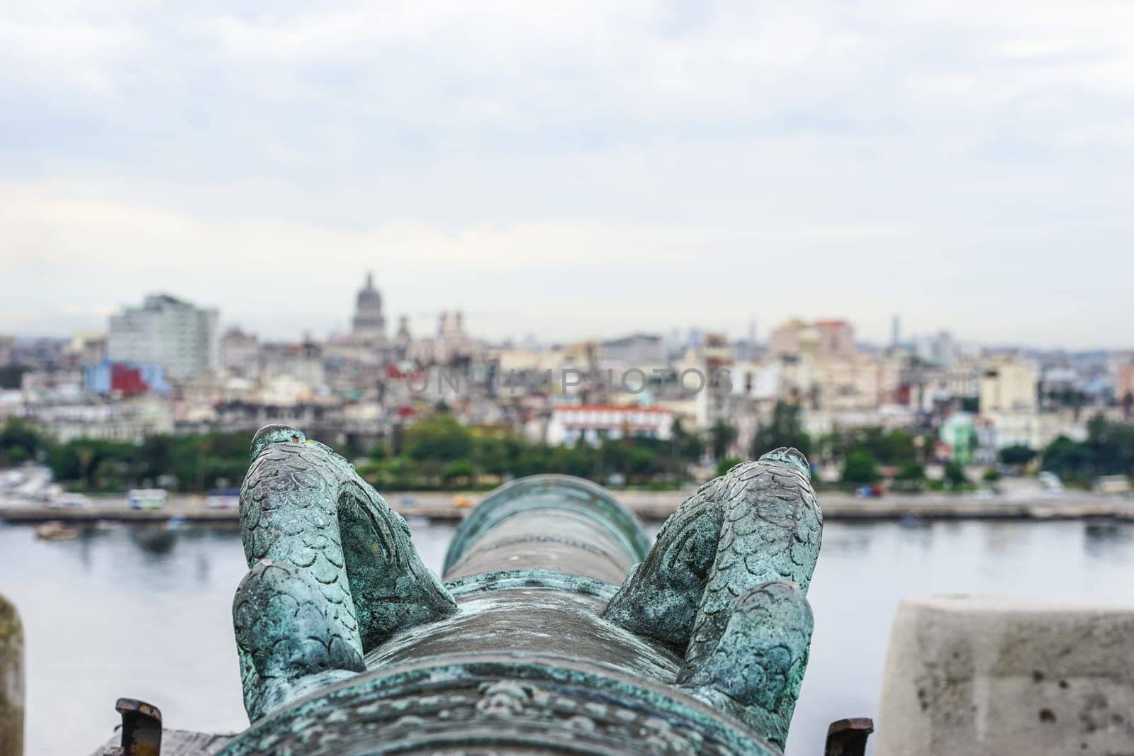 detail of old antique cannon overlooking the blurring city of havana, Cuba