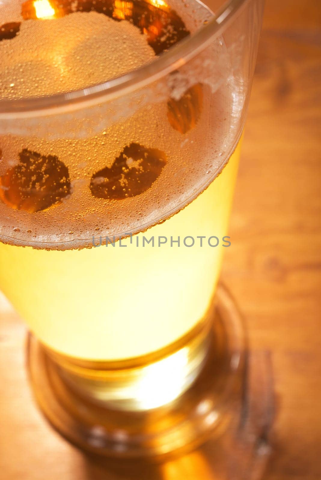 Close-up of a beer glass with foam on the table