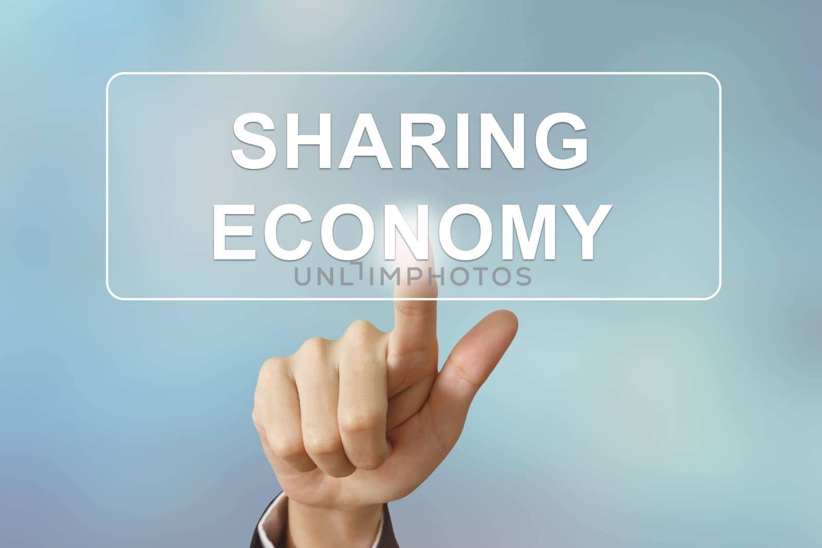 business hand pushing sharing economy button on blurred background
