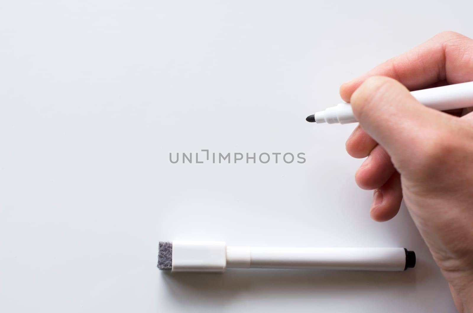 Human hand and whiteboard with place for text