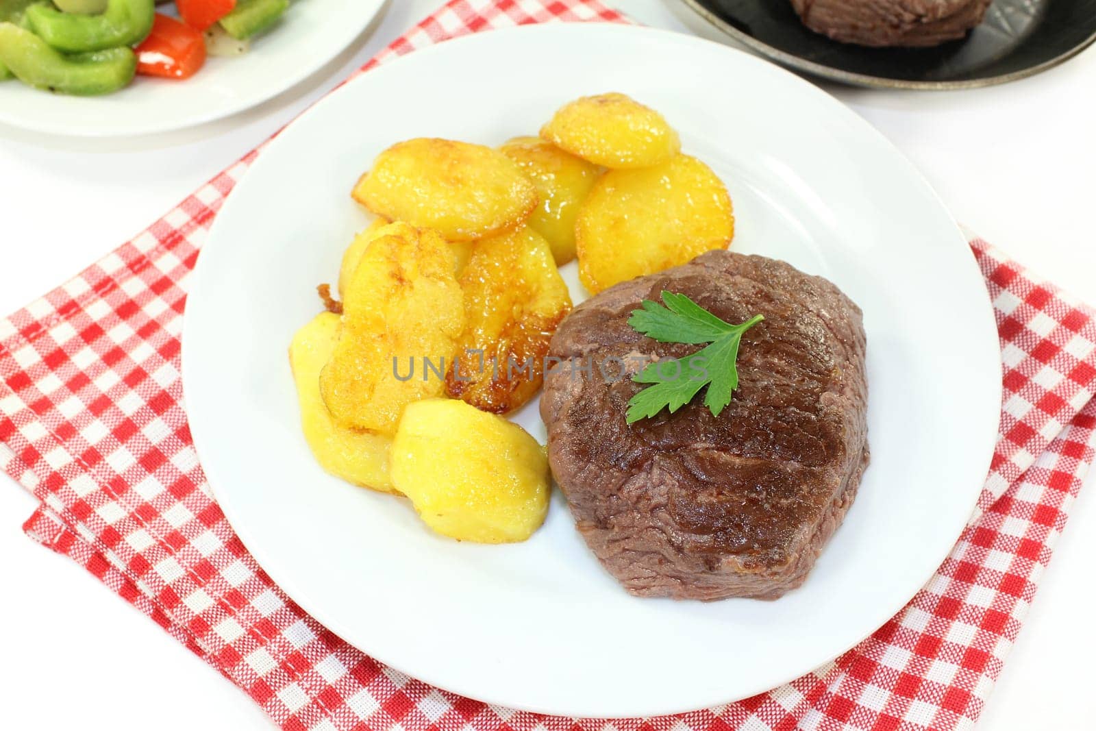 Ostrich steak with baked potatoes and peppers - Artichokes - Vegetables
