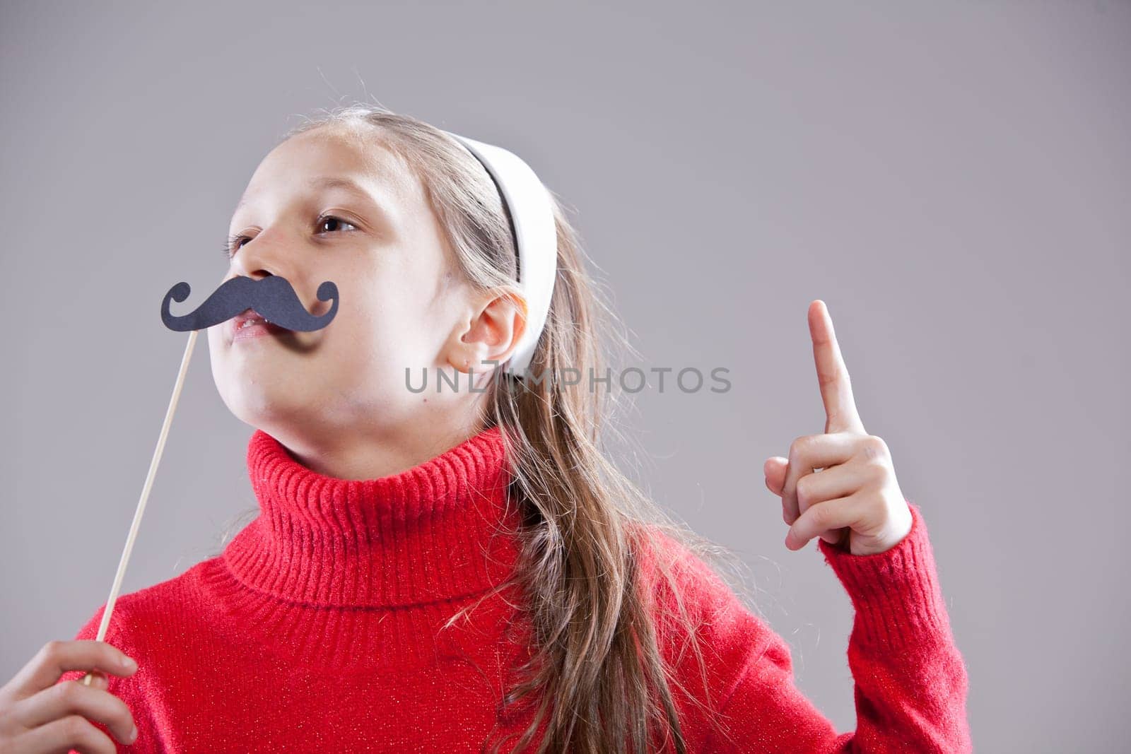 Little girl with fake mustache laying down the law being stuck up