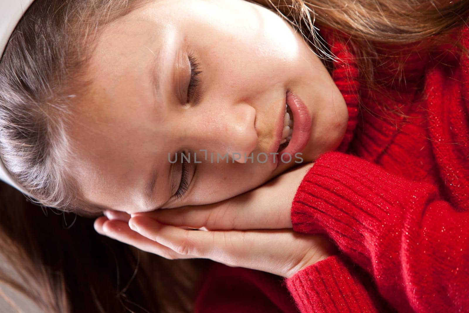 Little girl sleeping with her face on her hands