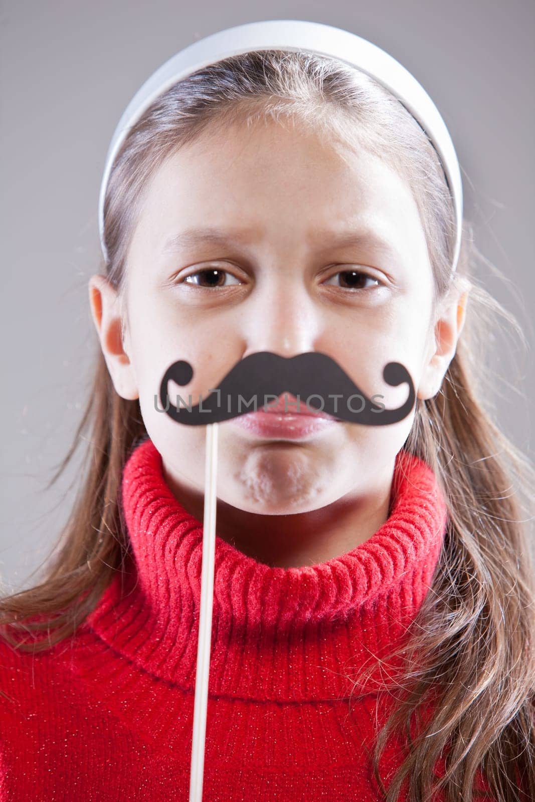 Little girl with fake mustache laying down the law being stuck up