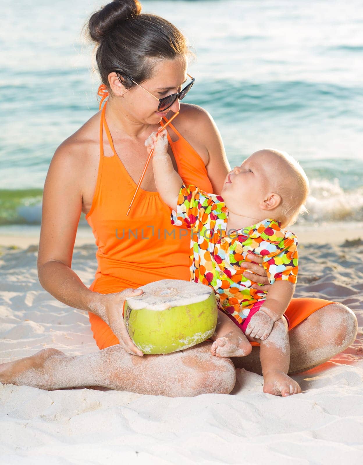 Baby and mother on the tropical beach