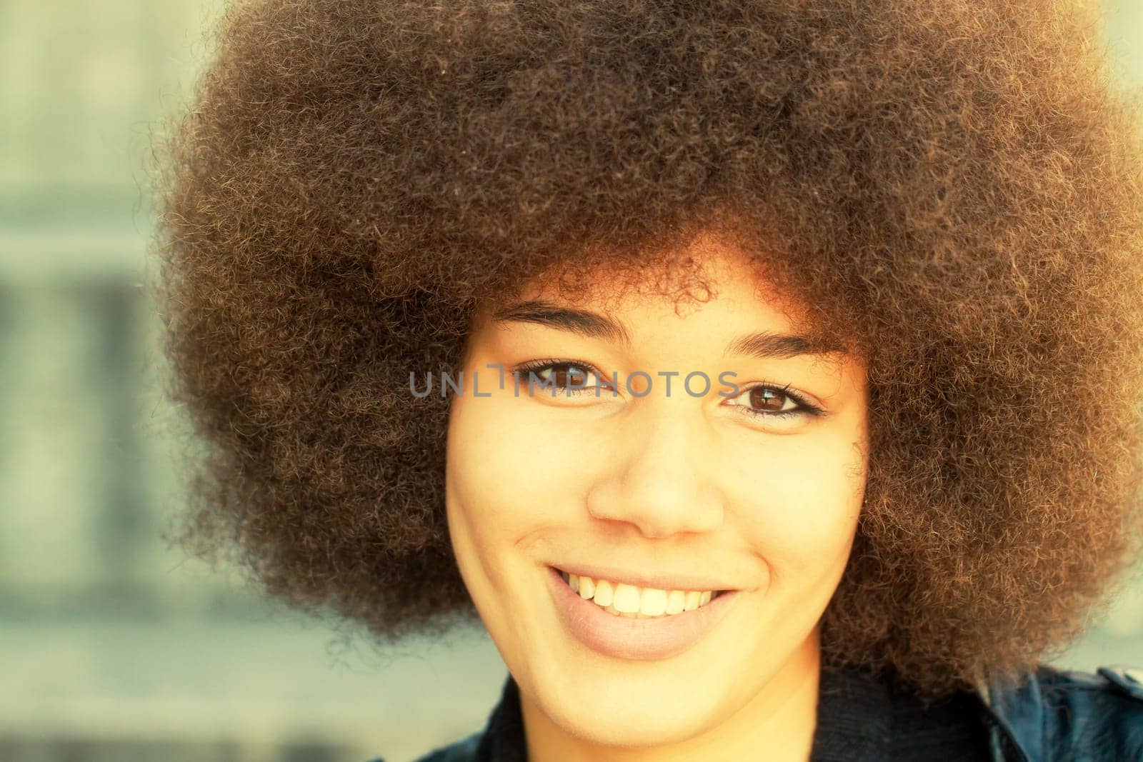 Portrait of a young woman with afrolook