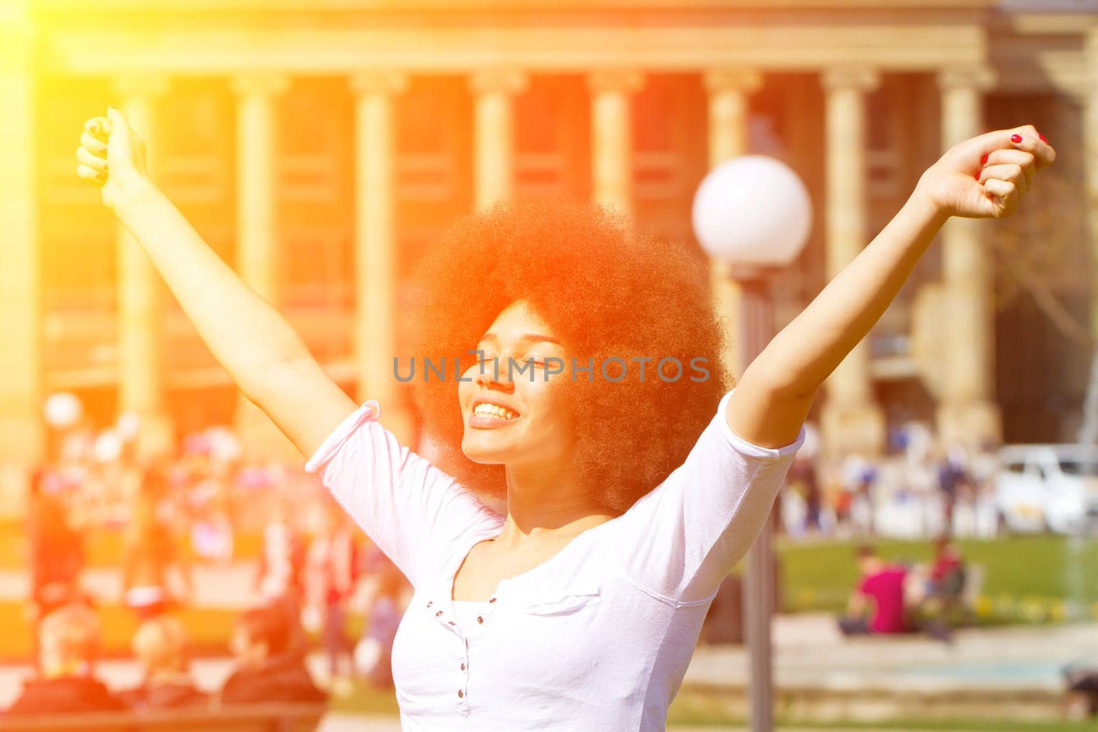 Young woman in the city enjoys the sun
