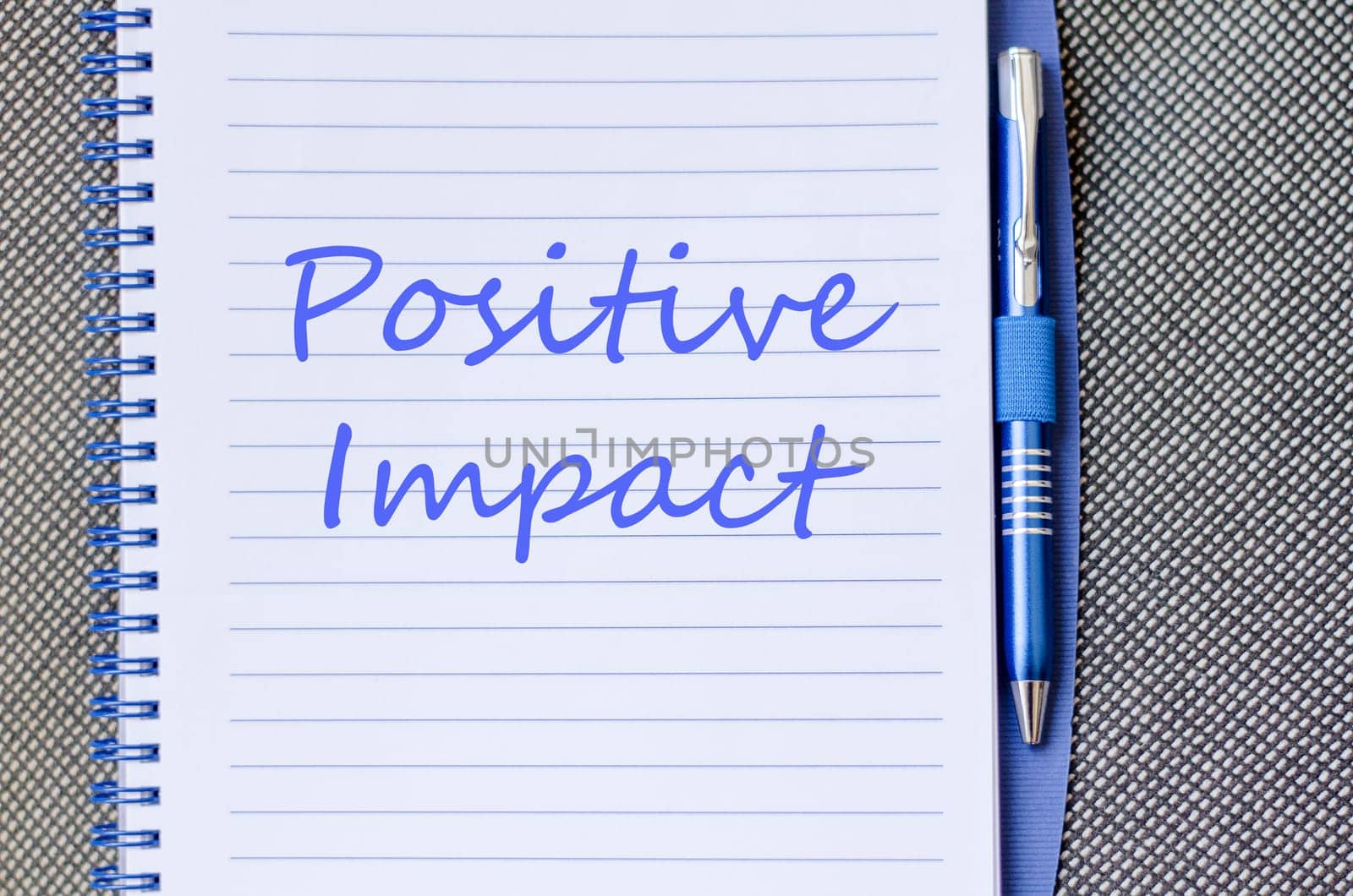 Positive impact text concept write on notebook with pen