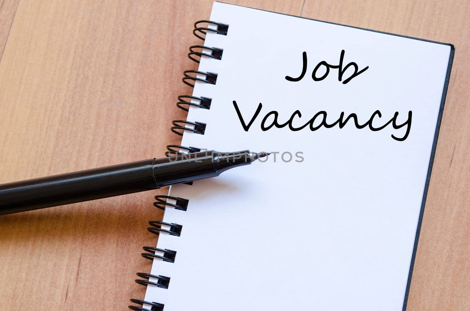 Job vacancy text concept write on notebook with pen