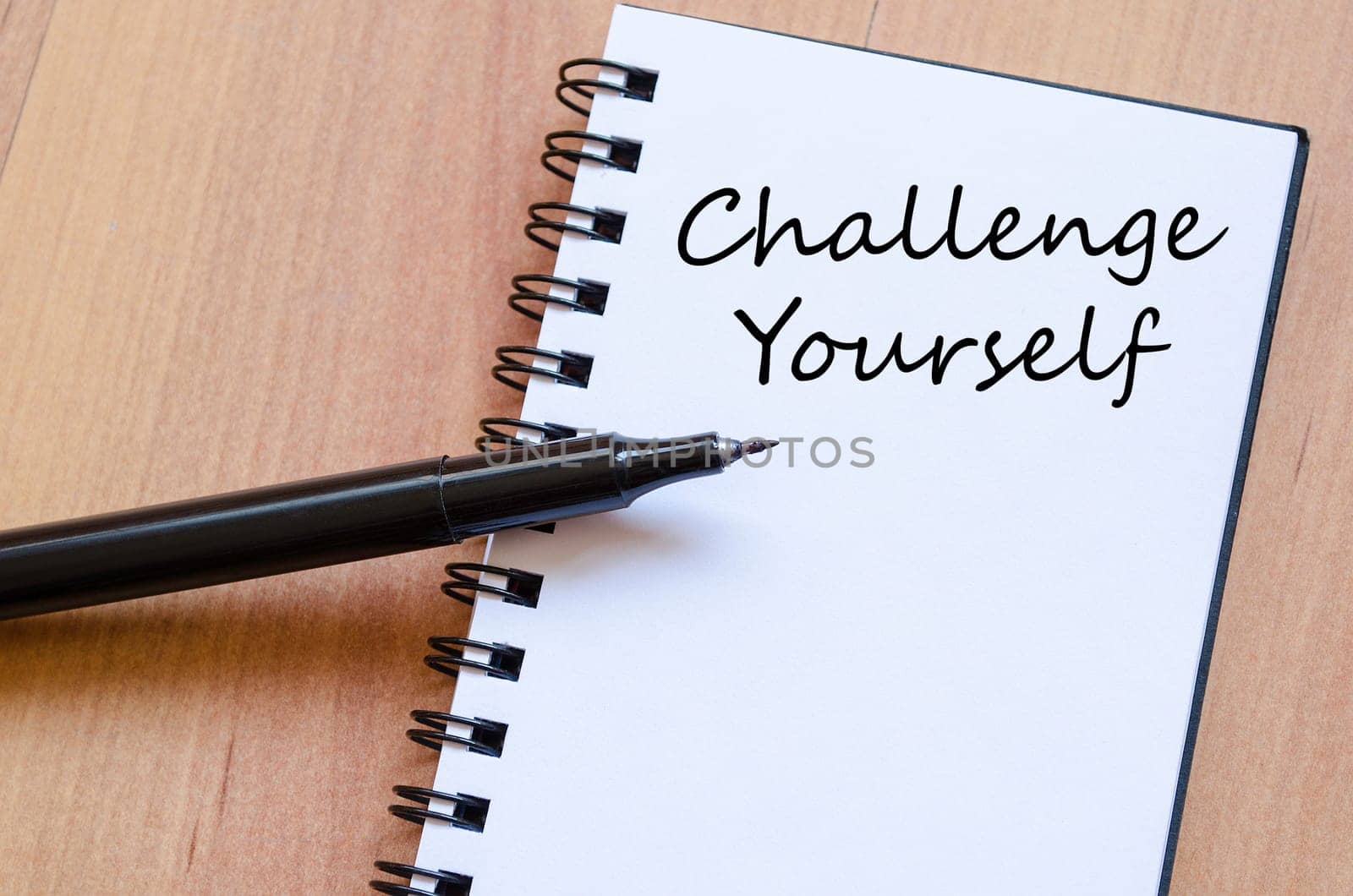 Challenge yourself text concept write on notebook with pen