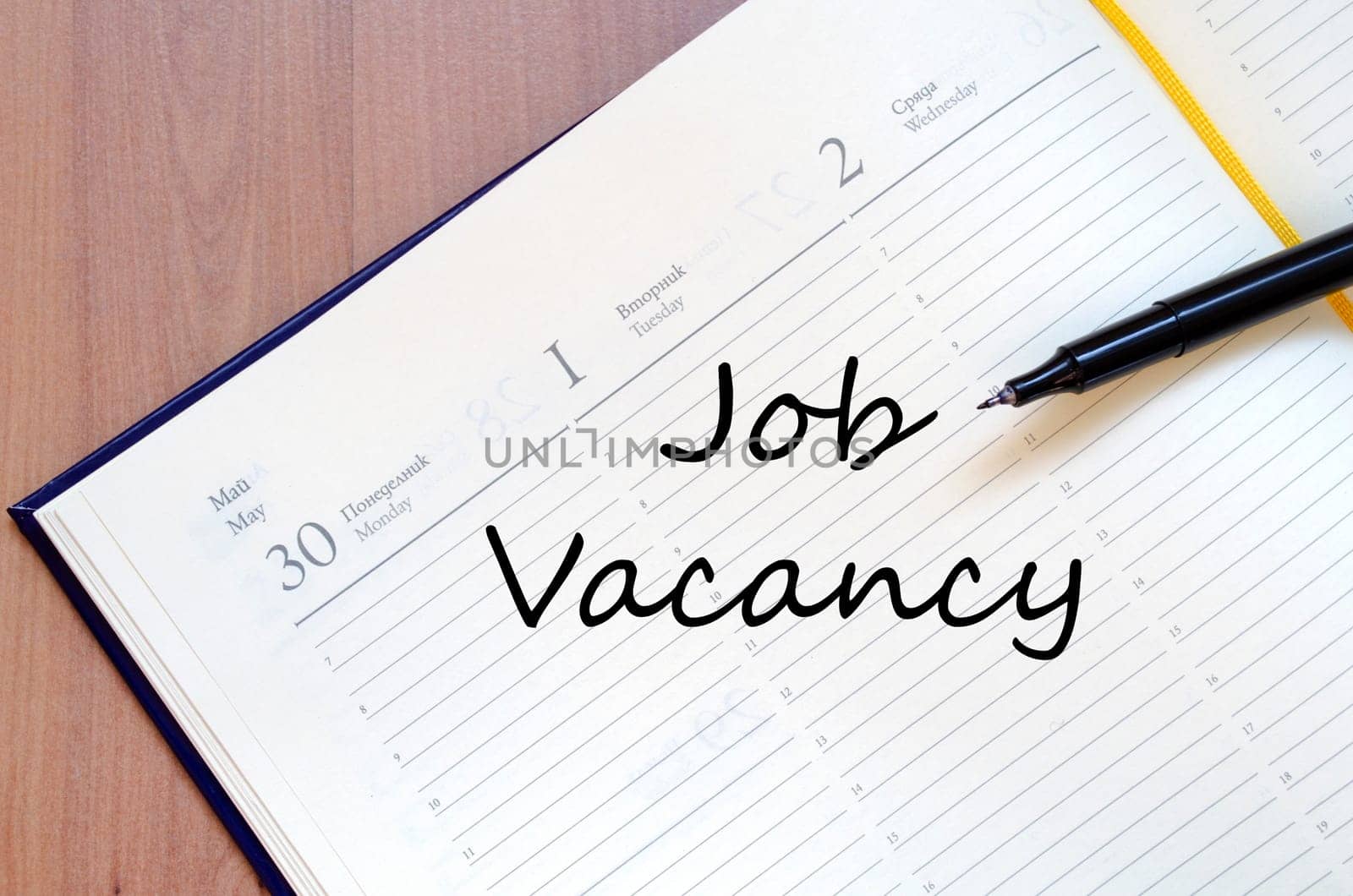 Job vacancy text concept write on notebook with pen