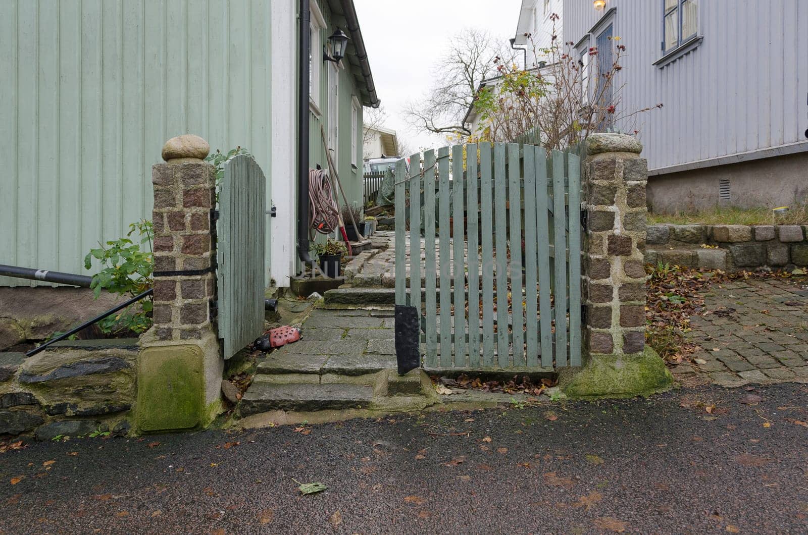 one old gate between the old house.in sweden