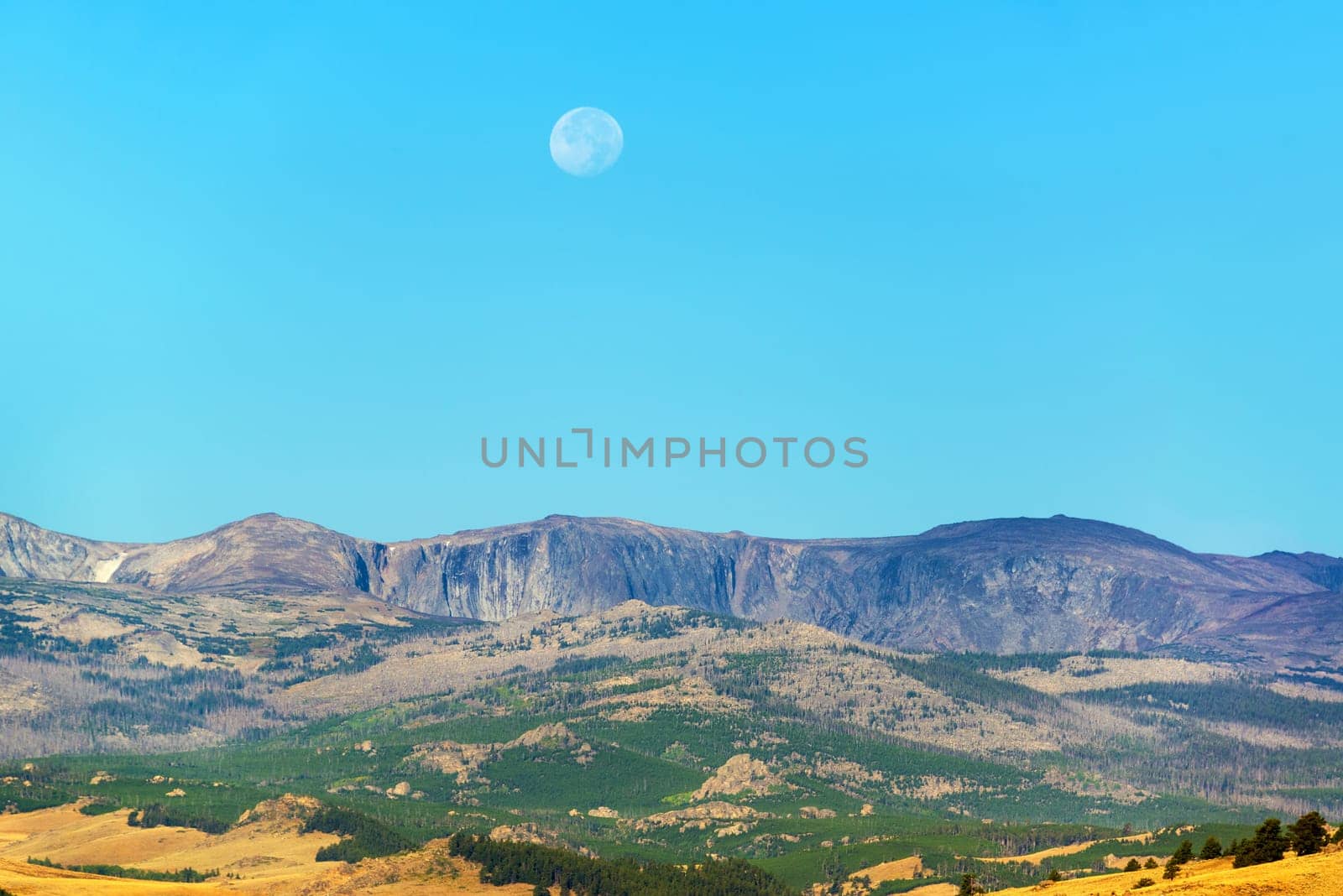 Early morning view of the moon over the Bighorn mountains near Buffalo, Wyoming