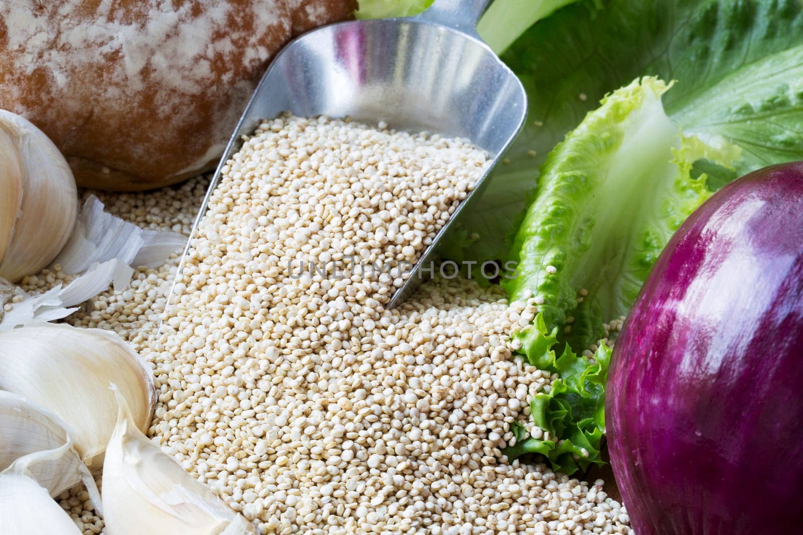 Scoop of quinoa surrounded by ingredients to make vegan Sloppy Joes.