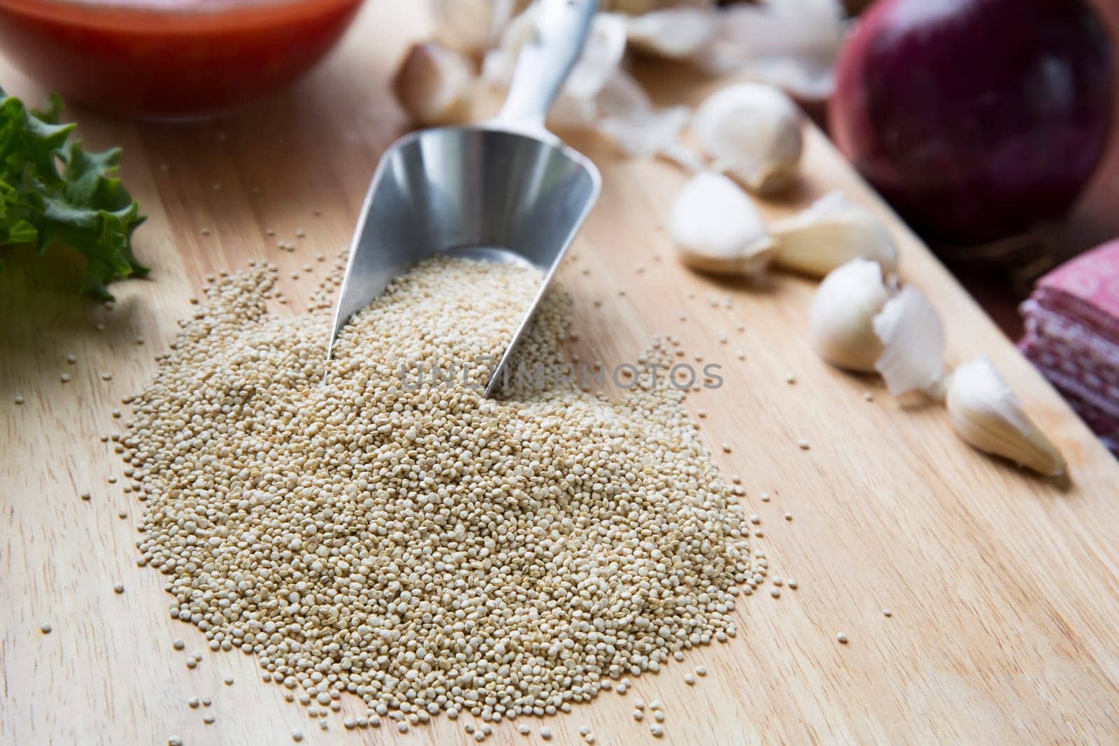 Scoop of quinoa surrounded by ingredients to make vegan Sloppy Joes.