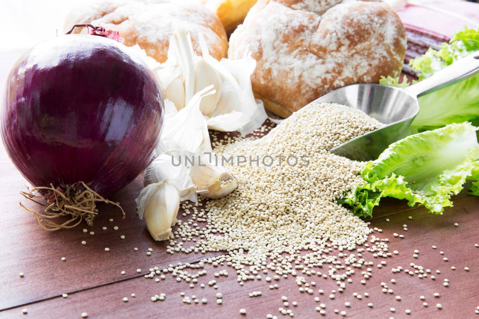 Scoop of quinoa surrounded by ingredients to make vegan Sloppy Joes.