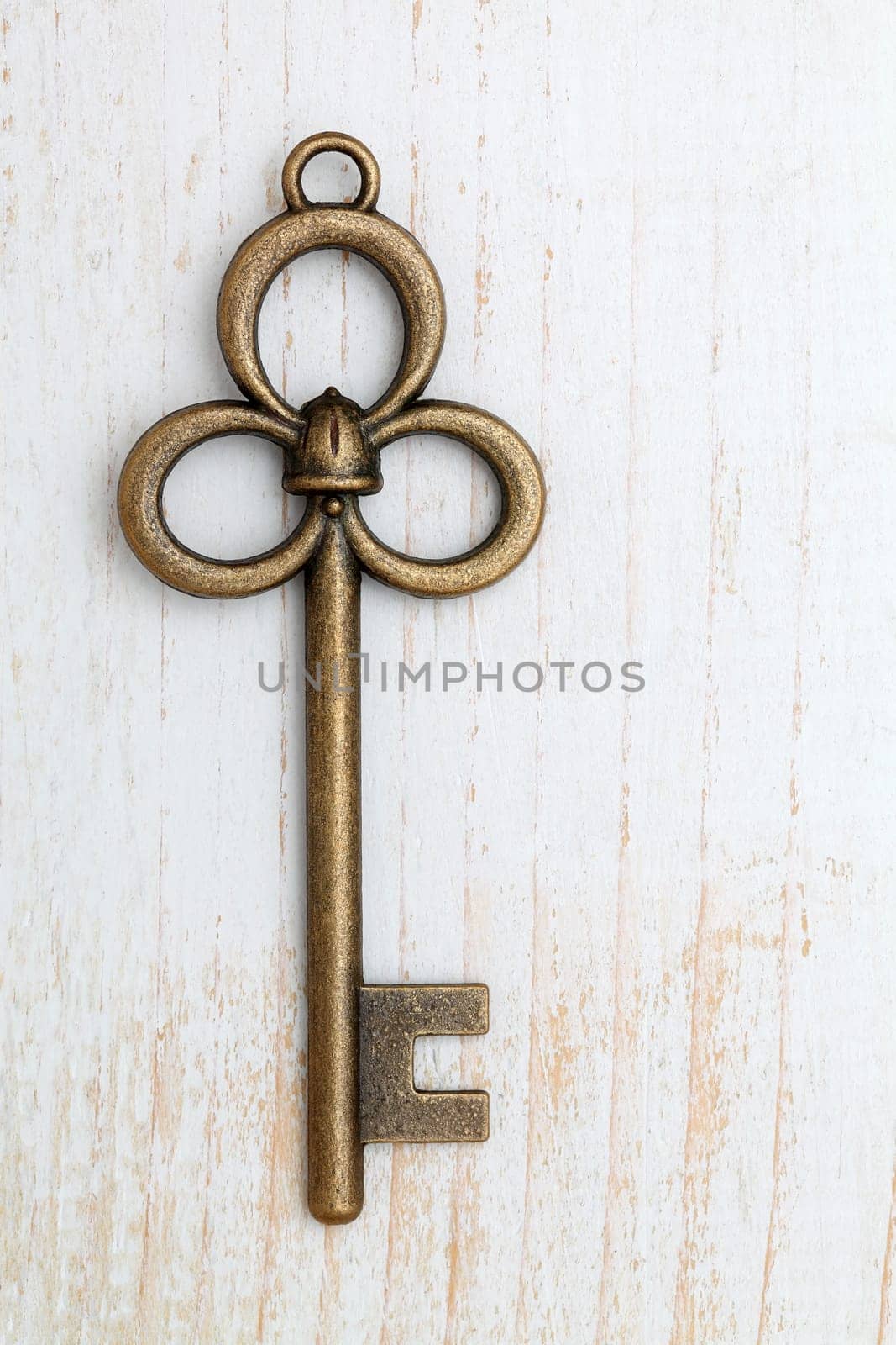Old key on white wood background