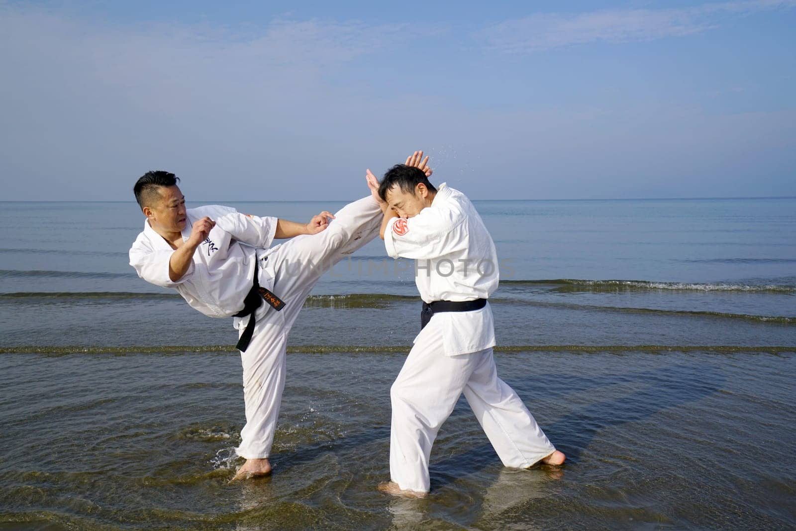 KAGAWA, JAPAN - Jan 3: Japanese karate men training of karate fighting in midwinter of a new year at Ichinomiya Beach, January 3, 2016, Kagawa, Japan