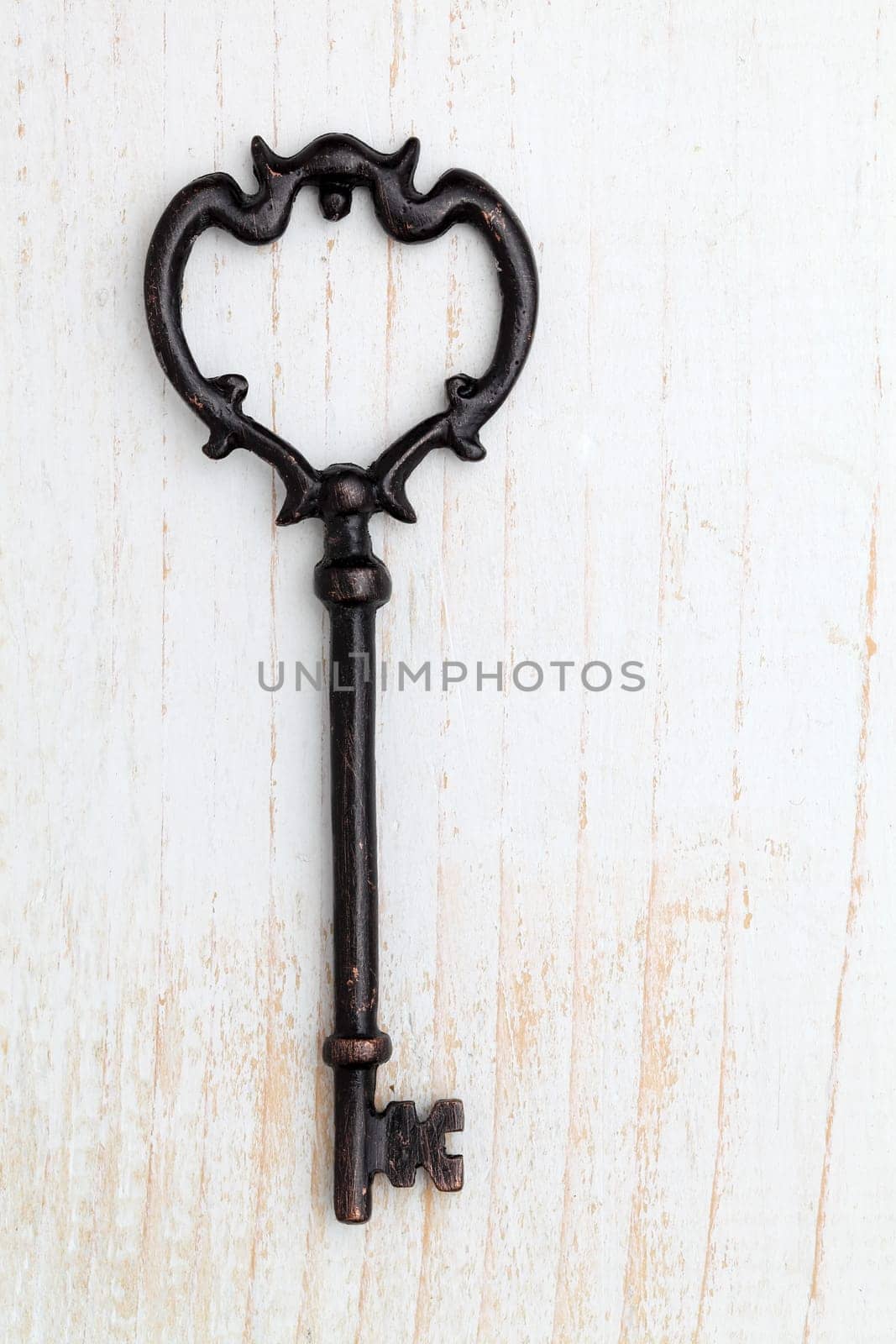 Antique key on white wood background