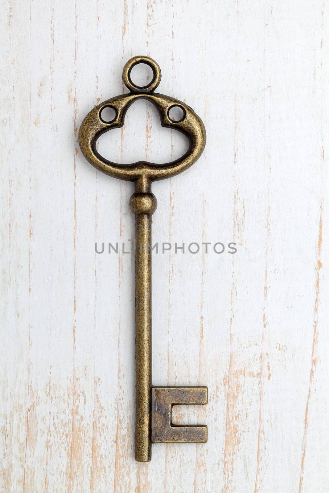 Antique rusty key on wood background