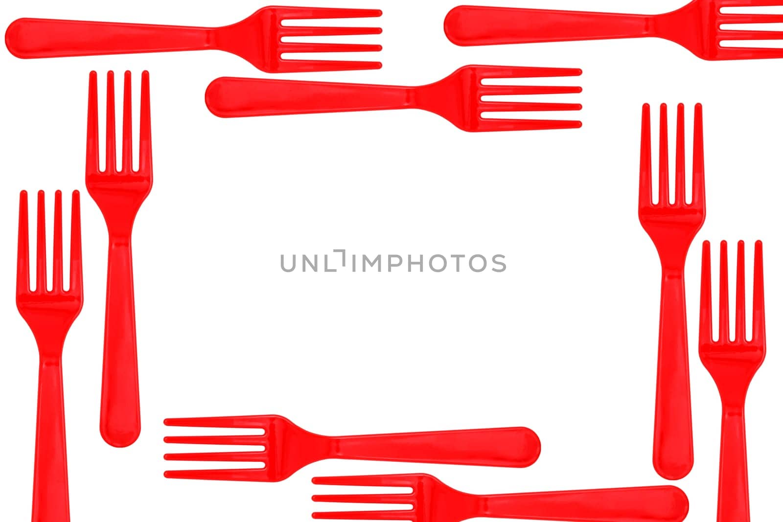 frame of plastic forks on wood background