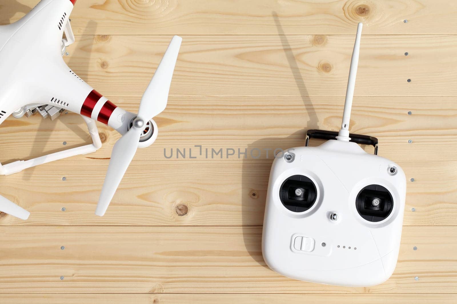 KAGAWA, JAPAN - MARCH 10, 2016: Close-up of drone quadrocopter Dji Phantom 3 Standard Remote Controller. New tool for aerial photo and video. Wooden table background.