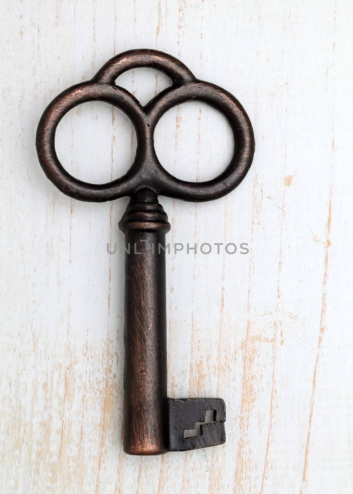 Antique key on white wood background