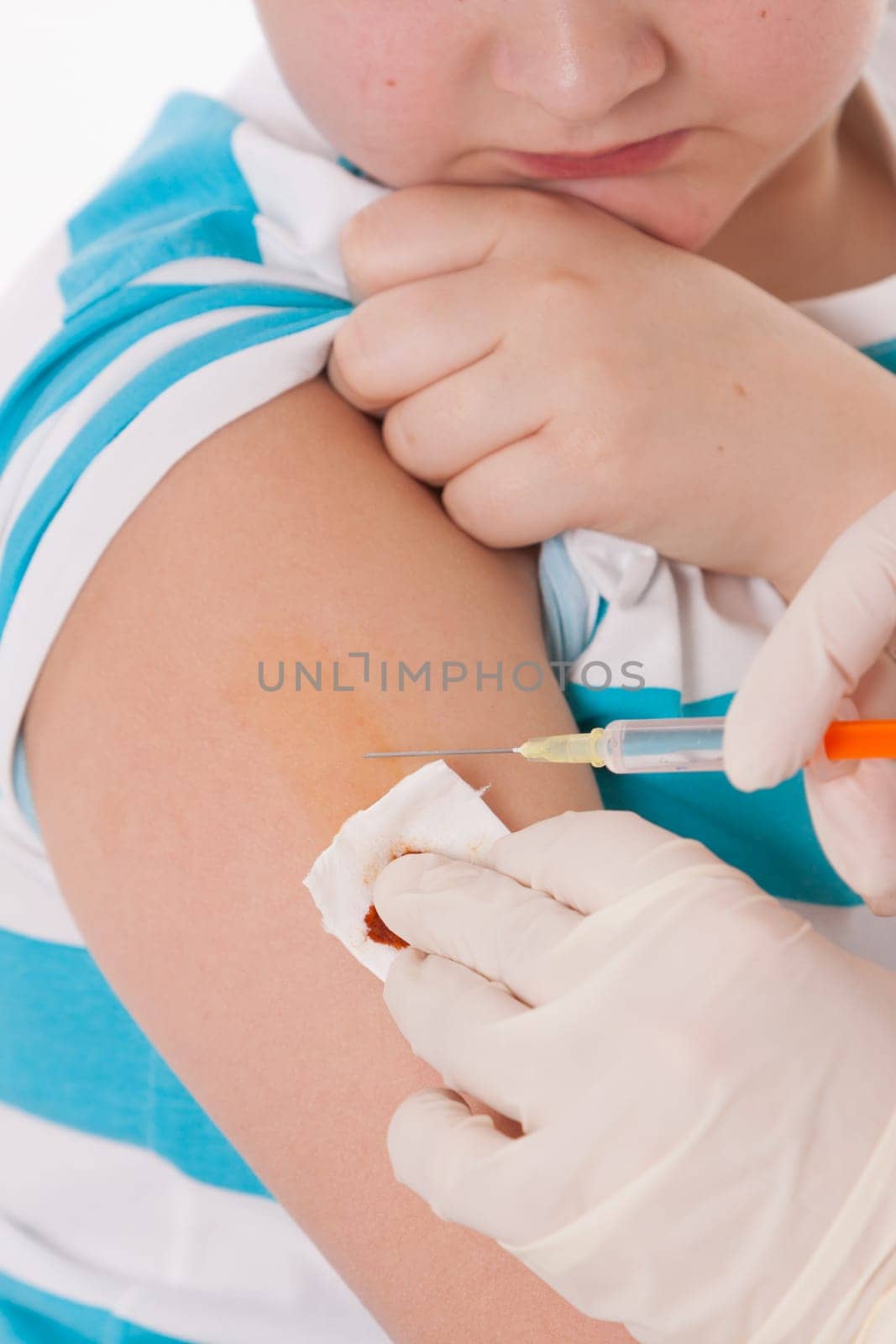 Doctor giving a child injection in arm on isolated image.