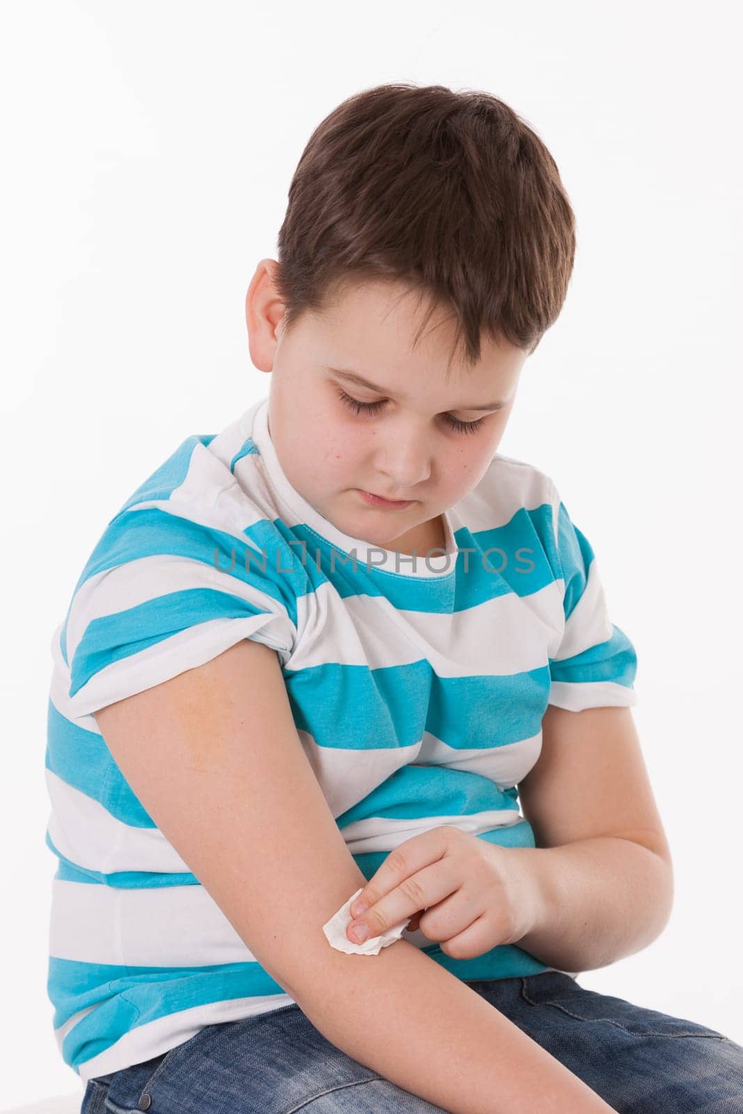 Doctor giving a child injection in arm on isolated image.
